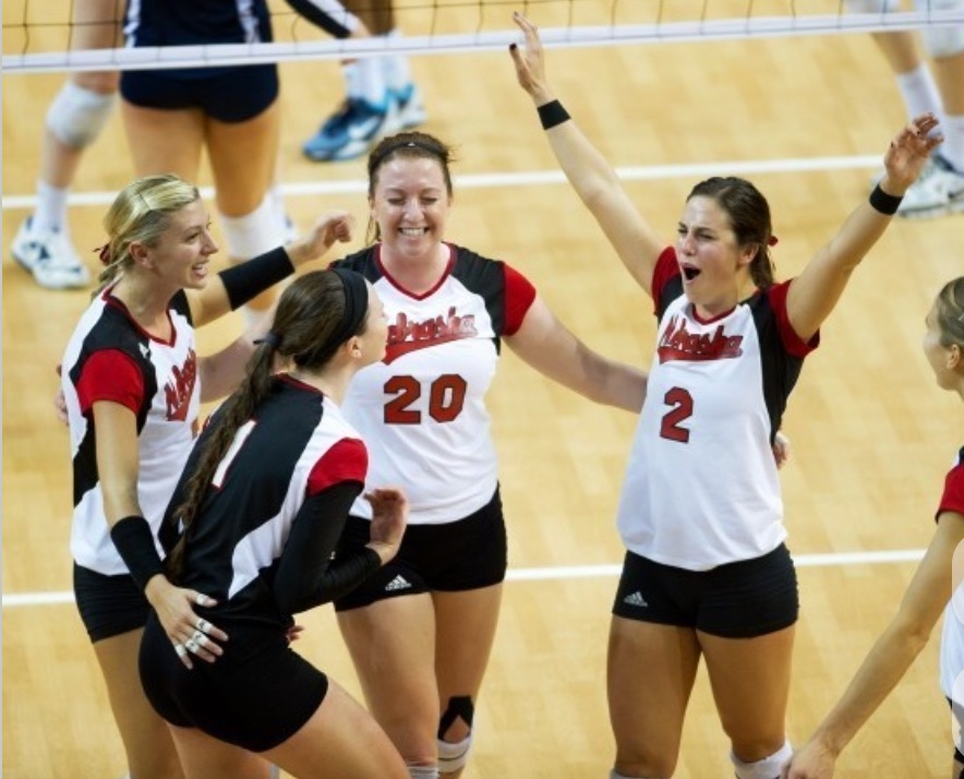Lara Dykstra celebrating a point with her Nebraska volleyball teammates