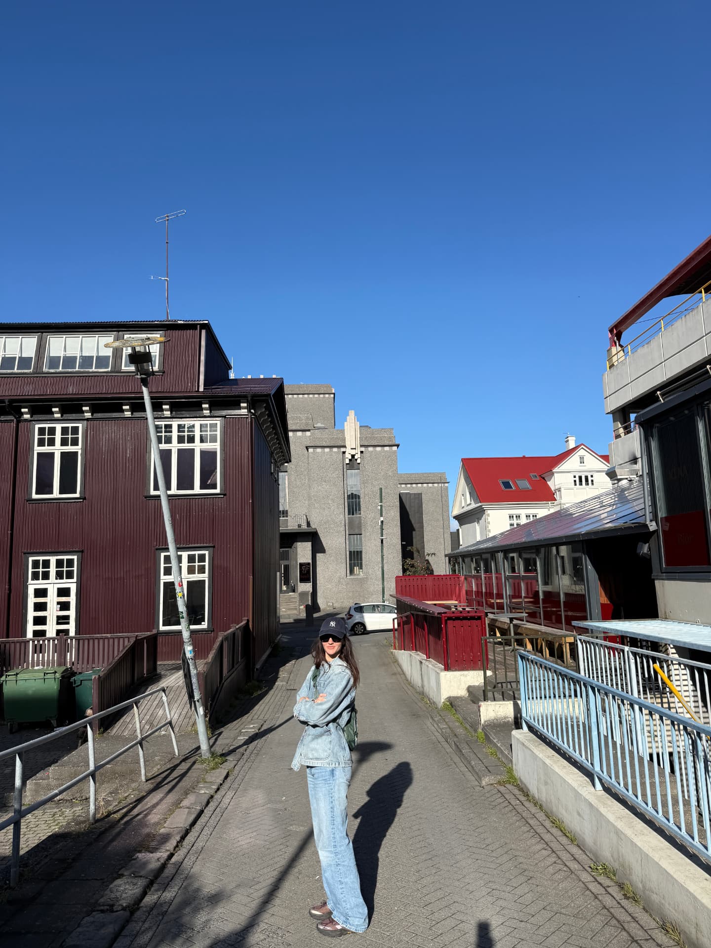 One of the founders in double denim on a sunny street between calls