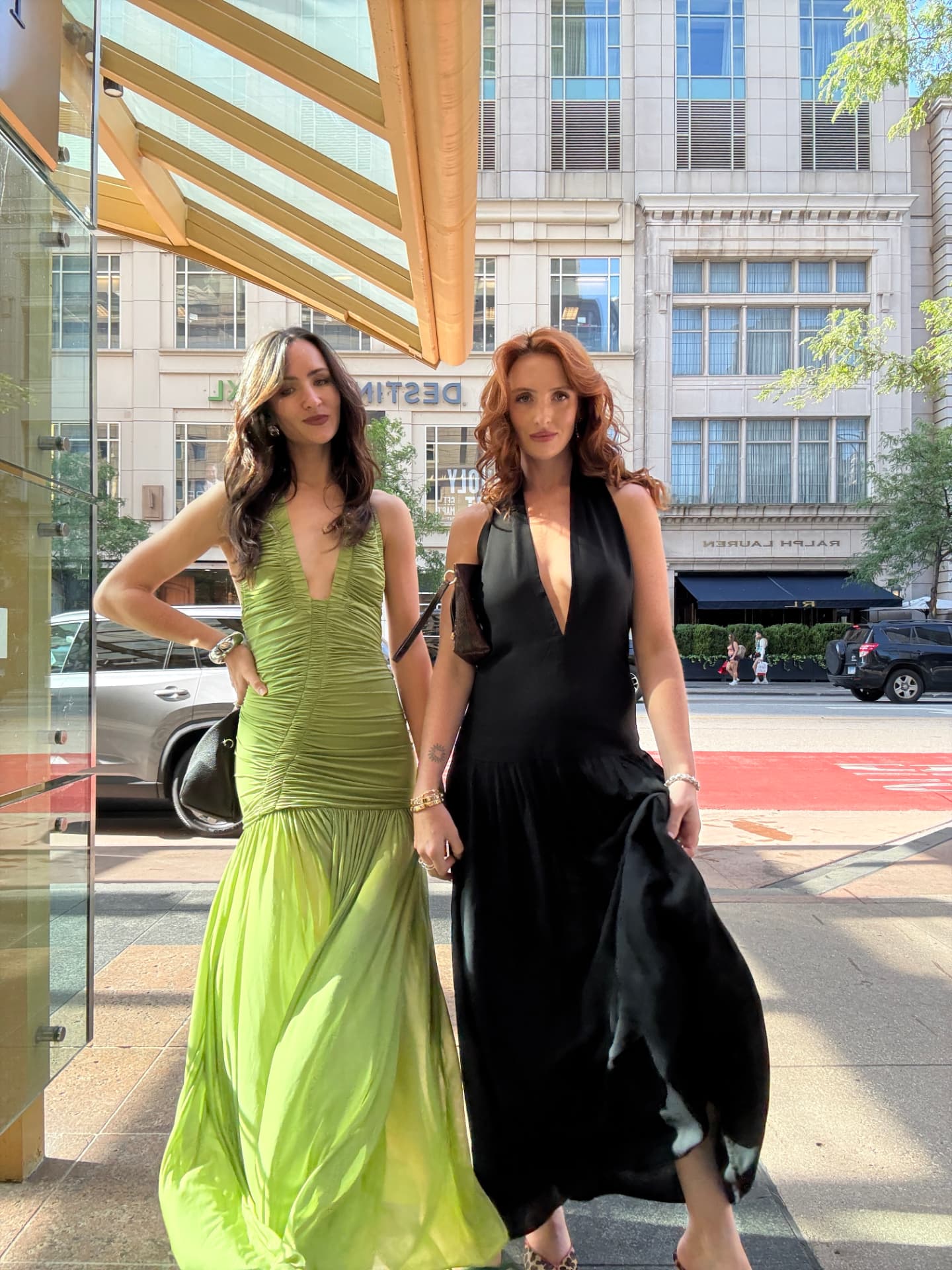 Lara and Skylar Dykstra posing together on a red carpet in evening gowns